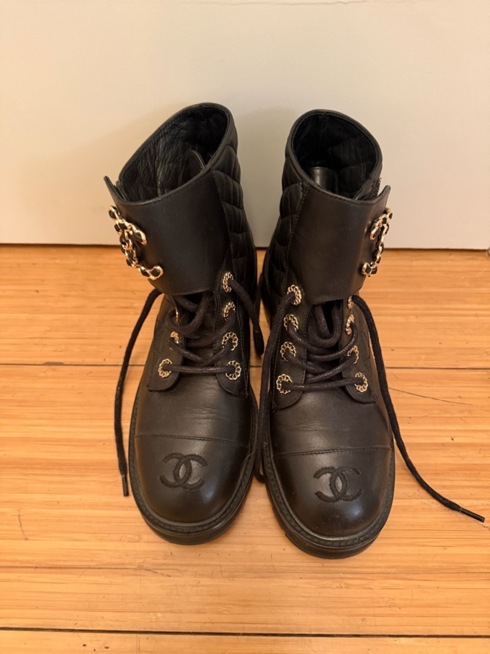 CHANEL Black Leather Quilted Ankle Boots with Gold Chain Accents